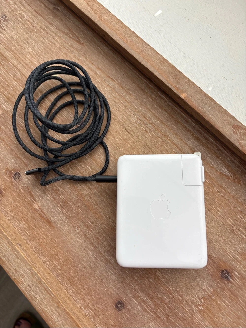 Apple 140w USB-C power adapter and black USB-C to MagSafe charging cord
